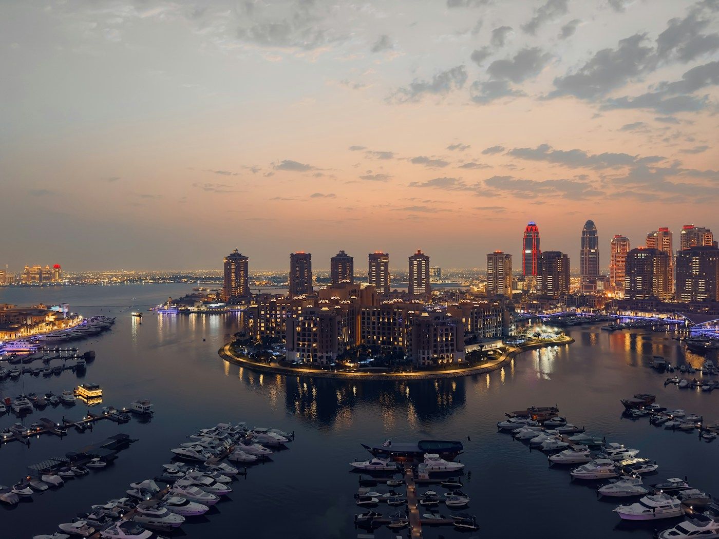 Marina and towers of The Pearl at dusk